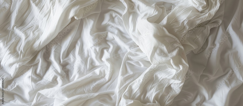 White bedding sheets seen from above after waking up in the morning. White bedding sheets seen from above after waking up in the morning.