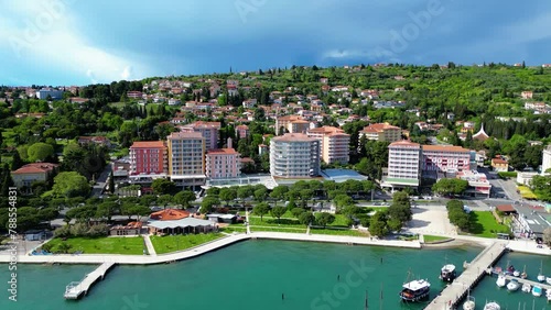 Portorož is a vibrant tourist destination nestled along the Slovenian Riviera, renowned for its pristine beaches, luxurious resorts, and vibrant atmosphere captured by drone photo