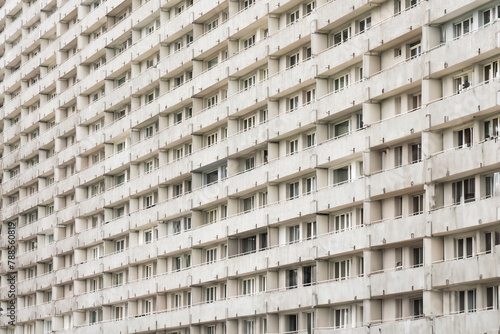 Tall concrete apartment block. Residental district. wall of windows and balconies. photo