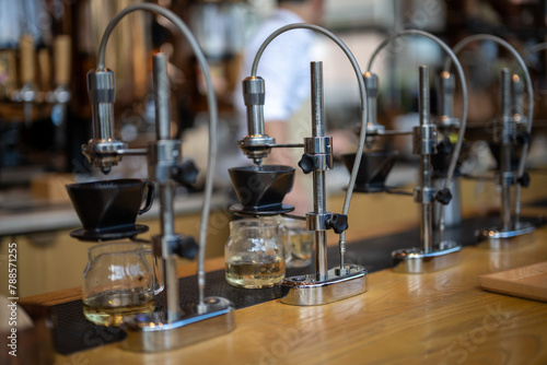 An array of sophisticated manual coffee brewing stands poised for crafting the perfect cup in a modern cafe setting.