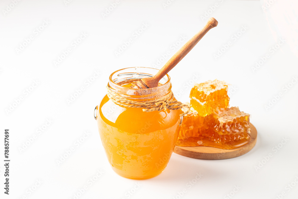 Honey dripping from a wooden honey dipper on white background. Healthy organic food concept. Honey dripping from a wooden honey dipper on white background. Healthy organic food concept.