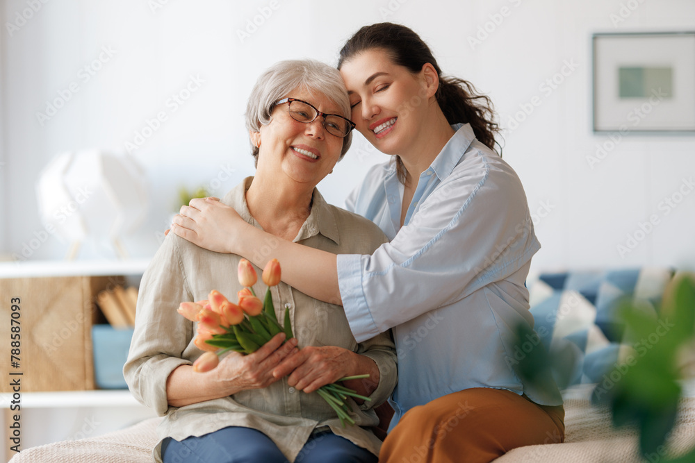 woman and her mother with flowers tulips - obrazy, fototapety, plakaty 