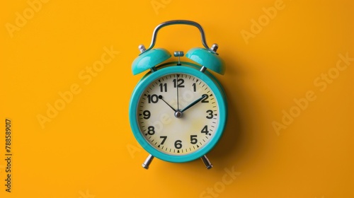 A blue alarm clock sitting on top of a yellow wall. Perfect for time management concepts