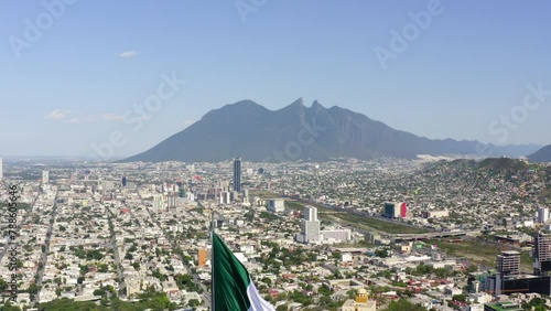 Aerial Descending Shot Of Tall Flag At Mirador Del Obispado In City Against Sky - Monterrey, Mexico photo