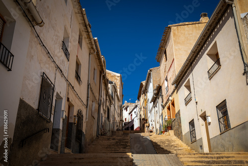 View from below of the steep and typical Planchas street in Caravaca de la Cruz, Region of Murcia, Spain, in spring