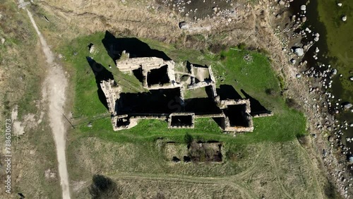 Ruins of Toolse Order Castle is one of the medieval castles on the northern coast of Estonia. Castle in green grass valleys and meadows overlooking ocean bay or sea. Baltic sea. (ID: 788630673)