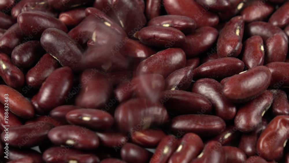 Red kidney beans falling onto scattered red beans, background Red kidney beans falling onto scattered red beans, background