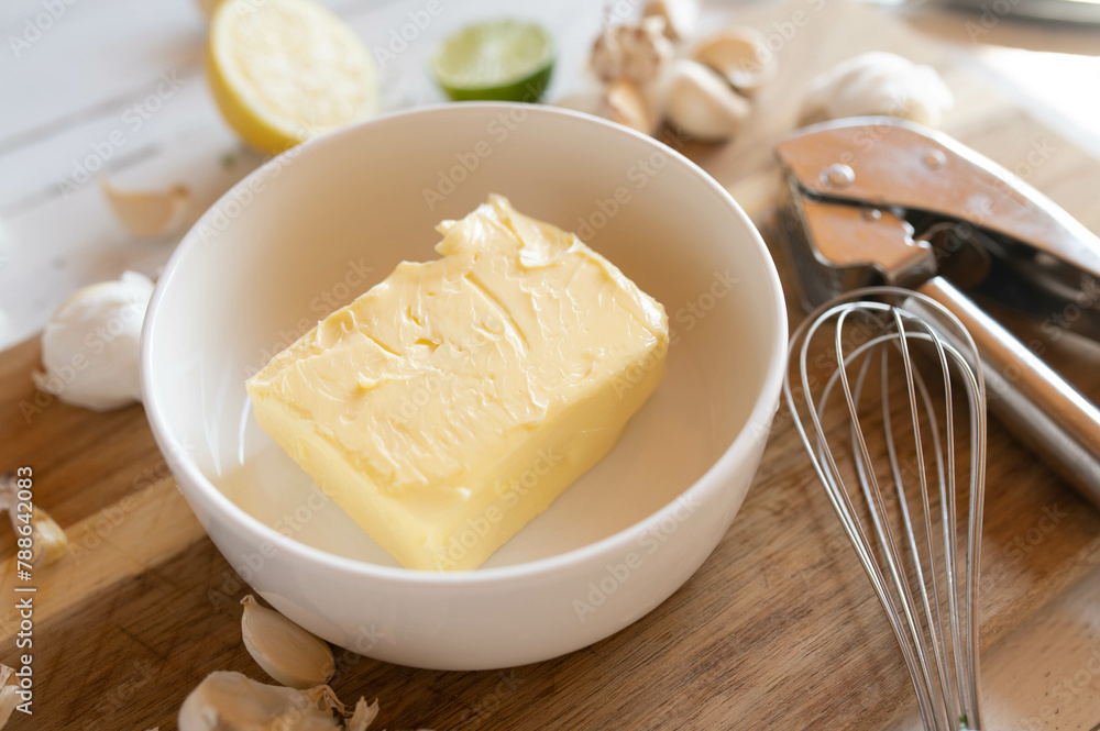 Ingredients for making garlic butter on a wooden cutting board Ingredients for making garlic butter on a wooden cutting board