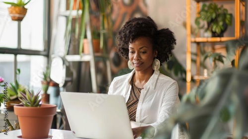 Businesswoman using laptop at modern home office