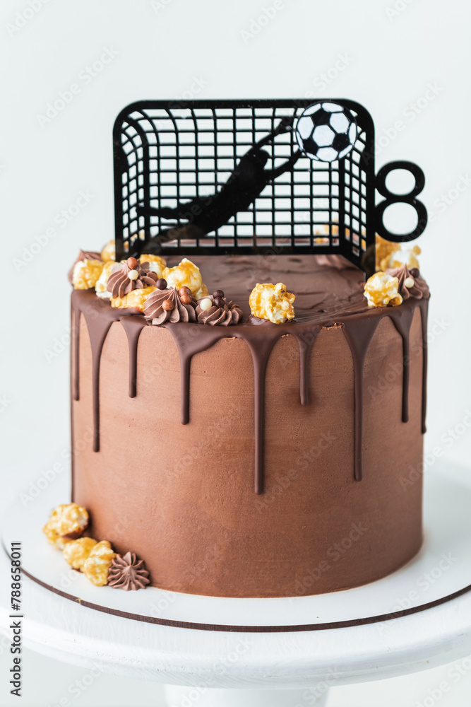 Birthday cake for a football fan with brown cream cheese frosting and