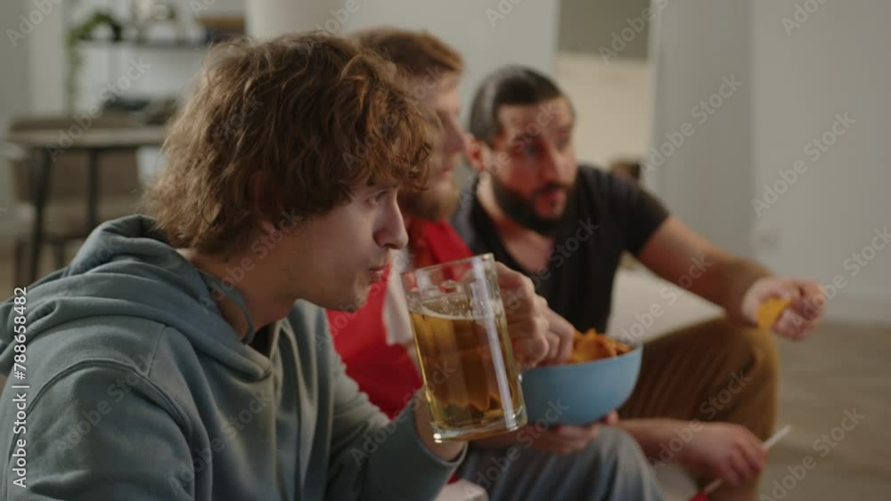 Males Spain fans watching football match on tv and drinking beer , cheering for Spain team. European and World football cup, Germany, USA, Canada, Mexico. Football, sports and soccer fans. Slow Motion Males Spain fans watching football match on tv and drinking beer , cheering for Spain team. European and World football cup, Germany, USA, Canada, Mexico. Football, sports and soccer fans. Slow Motion