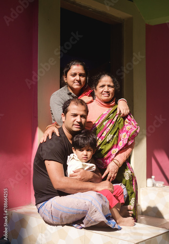 Portrait of a south asian hindu religious family sitting in a sunny day