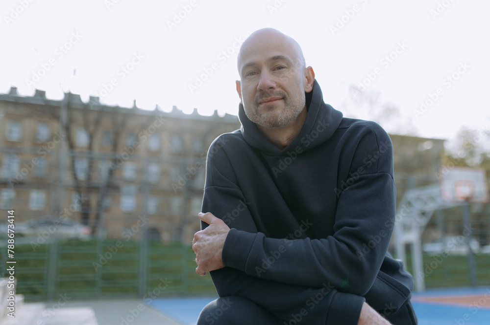 portrait of a bald athlete on the sports field after training portrait of a bald athlete on the sports field after training