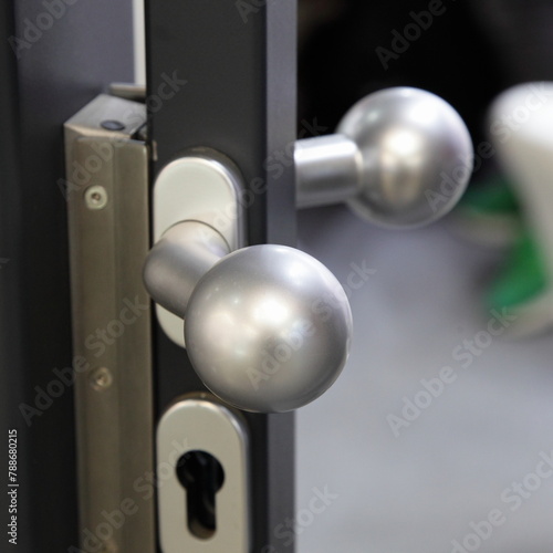 Metal safe door knob handle and lock with key on door closeup