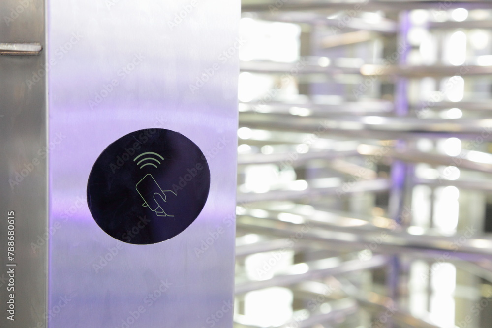 Pass card symbol on blurred barrier fence - automatic entrance gate security control