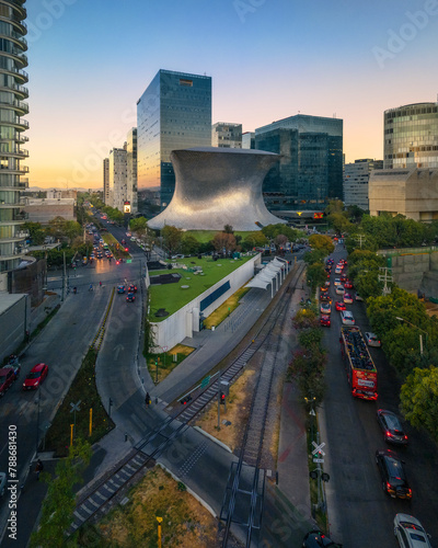 Aerial drone view of Soumaya Museum and train railway in Mexico City at daytime, Mexico. photo
