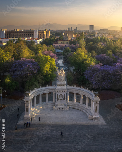 Aerial drone view of Hemiciclo a Juarez, a historic monument with jacaranda trees in Mexico City at sunrise, Mexico. photo