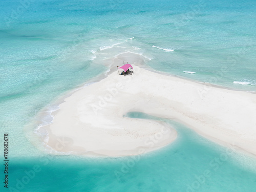 Aerial view of sandy beach with blue ocean and tropical tent, Vashafaru, Haa Alif, Maldives. photo