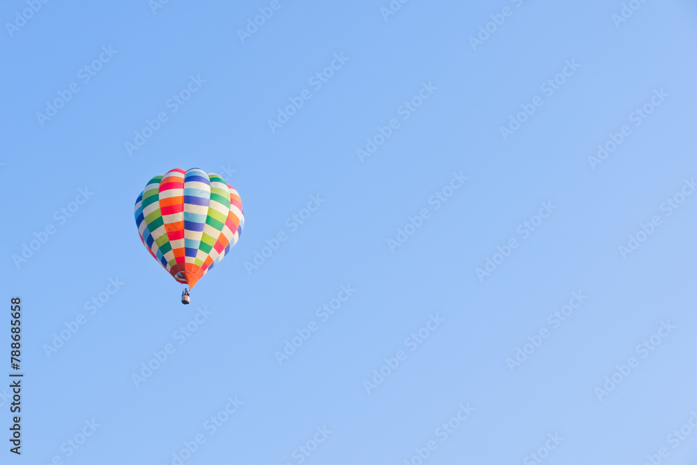 Hot air balloons landing in a mountain flight over field and forest,colorful Hot air balloons flying over the valley with blue sky,Tourism concept. Hot air balloons landing in a mountain flight over field and forest,colorful Hot air balloons flying over the valley with blue sky,Tourism concept.
