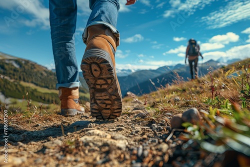 couple Hiking in the mountains, blue sky, low angle close up shot focus foot walking to hill