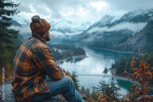 A semi-truck driver taking a break at a rest area with a view of a pristine lake, enjoying the tranquil surroundings photo