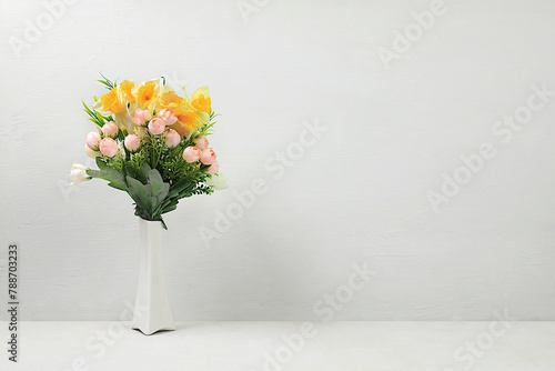 Beautiful spring floral arrangement.Empty podium for product with fresh flowers of daffodils and primroses,elegant beauty concept.Stage for product display and business concept