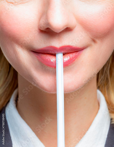 Woman drinking from a straw