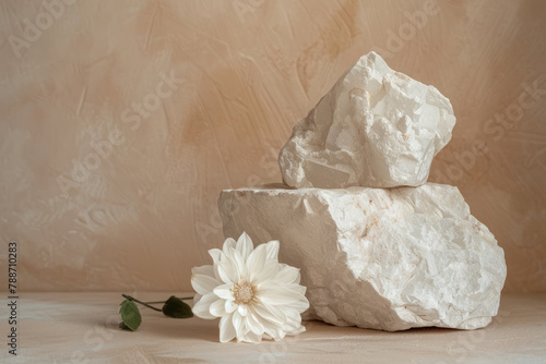 White stones podium with flower on beige textured background. Minimalistic composition, object display mockup. © Chili