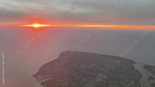 High altitude aerial view of the province of Zeeland in southern Netherlands, Holland. Delta islands connected with bridges and dikes along the North Sea coastline and British Channel during sunset photo