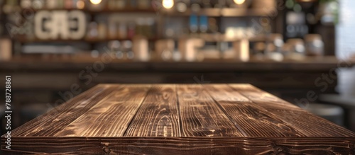 Wooden board on a clear table with a blurred background in a coffee shop setting. This brown wood surface can be utilized for showcasing or presenting your products. Ideal for product displays. © Vusal