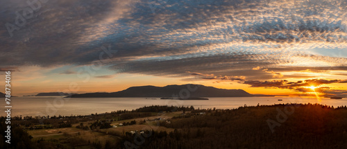 Panoramic sunset aerial view of Orcas Island seen from Lummi Island, Washington.  Looking across Rosario Strait towards the San Juan Islands with a dramatic sunset sky over Orcas Island.