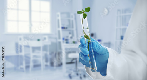 Scientist holding test tube...
