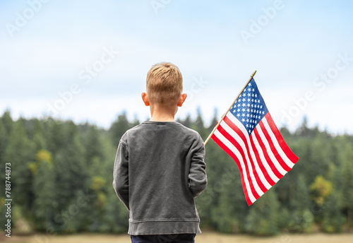 Child holding American USA flag outdoors, people patriotism, 4th of July concept.  © kieferpix