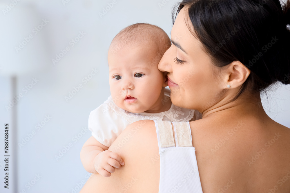 Happy mother with cute little baby in room at home Happy mother with cute little baby in room at home