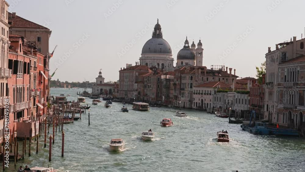 Traditional gondolas in Venice sailing through the narrow canals near ...