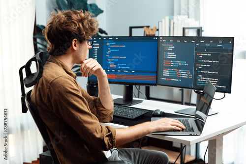 Fototapeta Working IT developer with stressful overworked in creating online software development coding on pc screen, thinking program for latest version application on website project at modern office. Gusher.