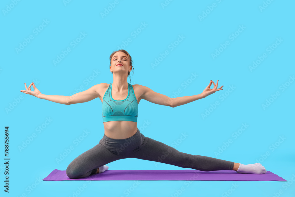 Young woman doing yoga on blue background Young woman doing yoga on blue background