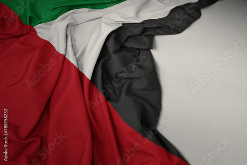 waving national flag of united arab emirates on a gray background.