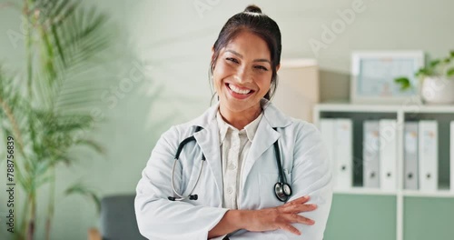 Face, doctor and woman with arms crossed, smile and office with healthcare and professional. Portrait, general practioner and physician with confidence and medical with stethoscope and photo