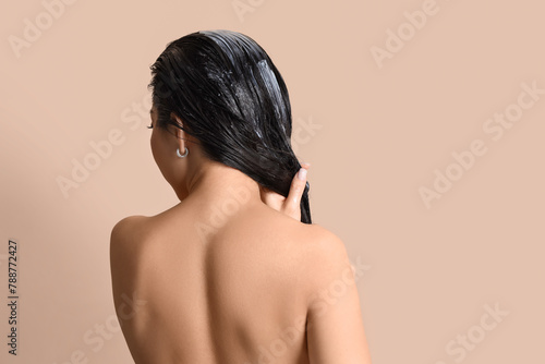Young woman applying hair m...