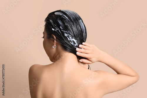 Young woman applying hair m...