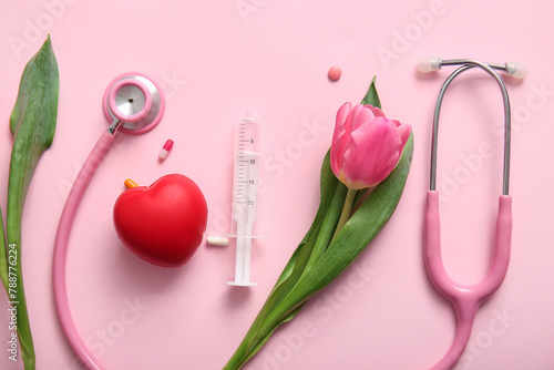 Stethoscope with tulip, syringe and heart for International Nurses Day on pink background