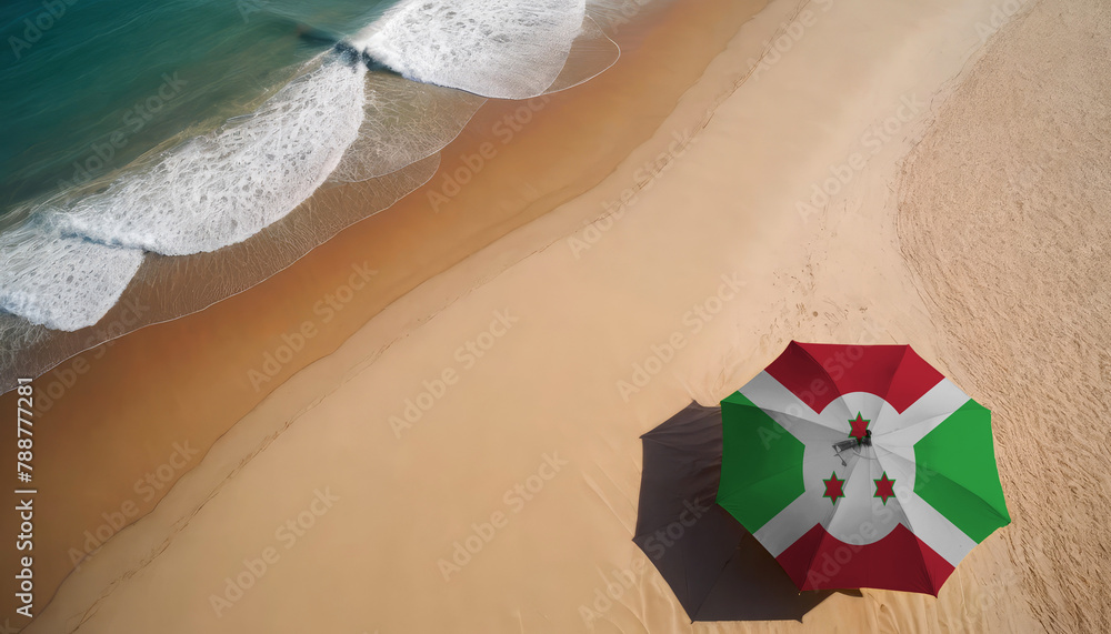 Naklejka premium An aerial vista of a sandy beach with gentle ocean waves, featuring a beach umbrella adorned with the Burundi flag. Ideal for Burundi tourists seeking seaside relaxation