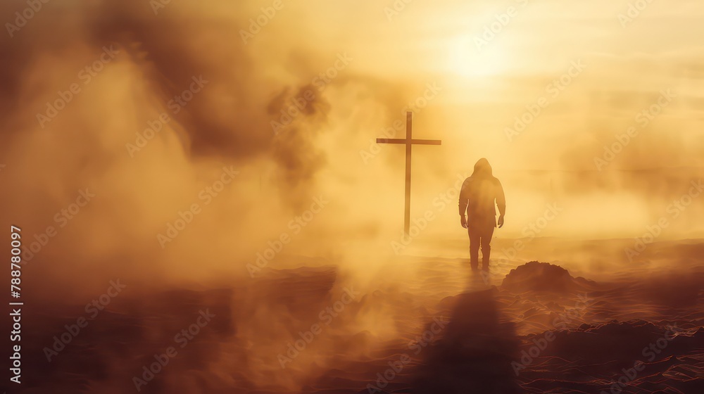 Obraz premium Silhouette of a man in the desert with a cross in the smoke and dust under the sun