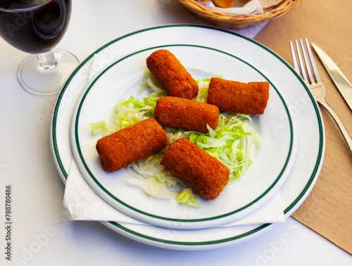 Spanish flamenquines, breaded pork loin rolled with serrano ham, typical of Andalusia photo