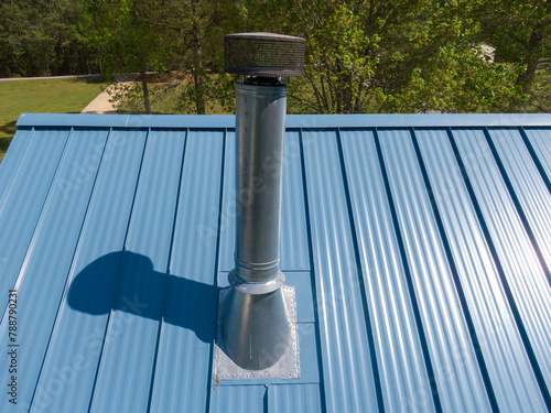 New steel metal light blue roof on a single family home featuring 5V style panels.  photo