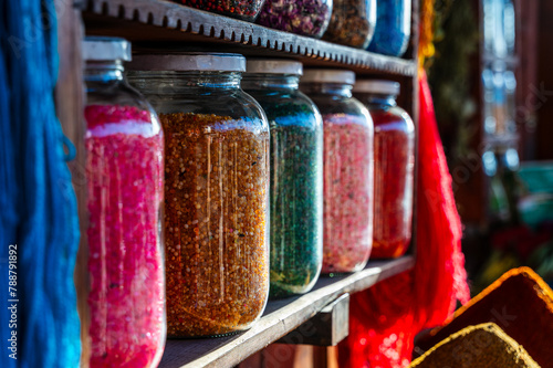 Colorful Moroccan spices and dyes in glass jars photo