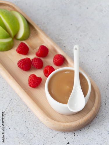 applesauce in a saucepan, with raspberry and apple fruit