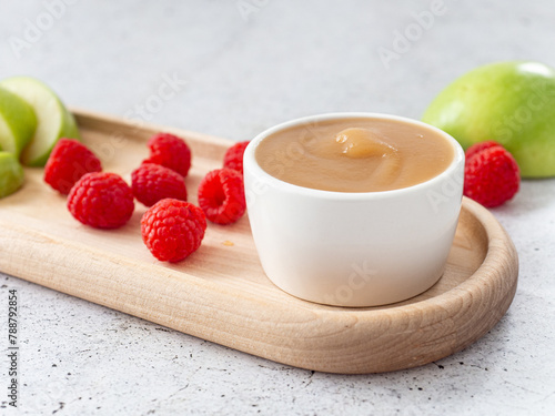 applesauce in a saucepan, with raspberry and apple fruit