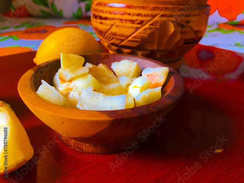 Ripe Abiu fruit cut and served in wooden pan photo